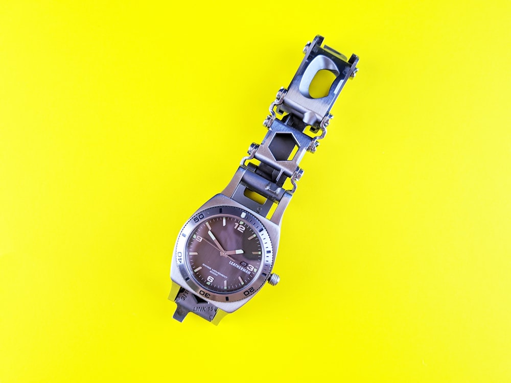 a watch sitting on top of a yellow surface