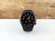 a watch sitting on top of a white table