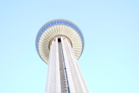 a tall white tower with a sky background