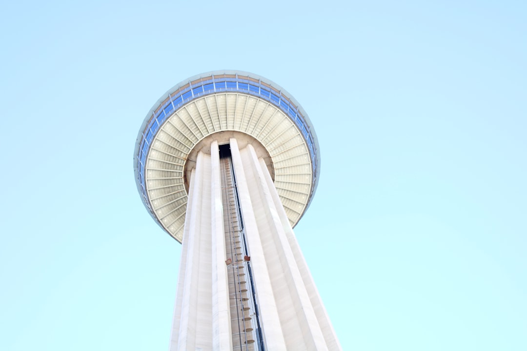 a tall white tower with a sky background,
