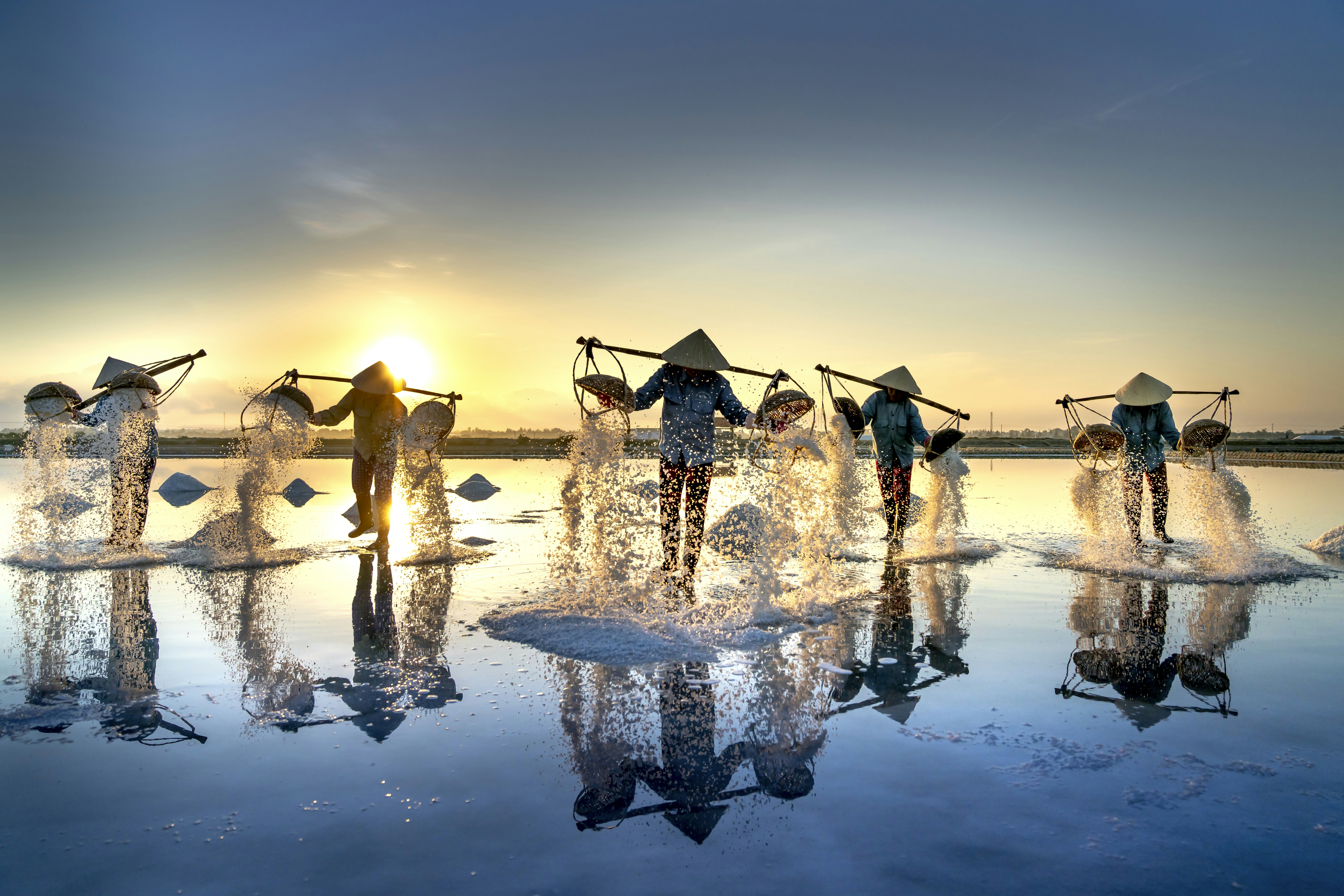 a group of people standing on top of a body of water