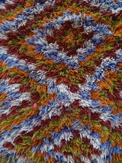 a multicolored rug with a circular design