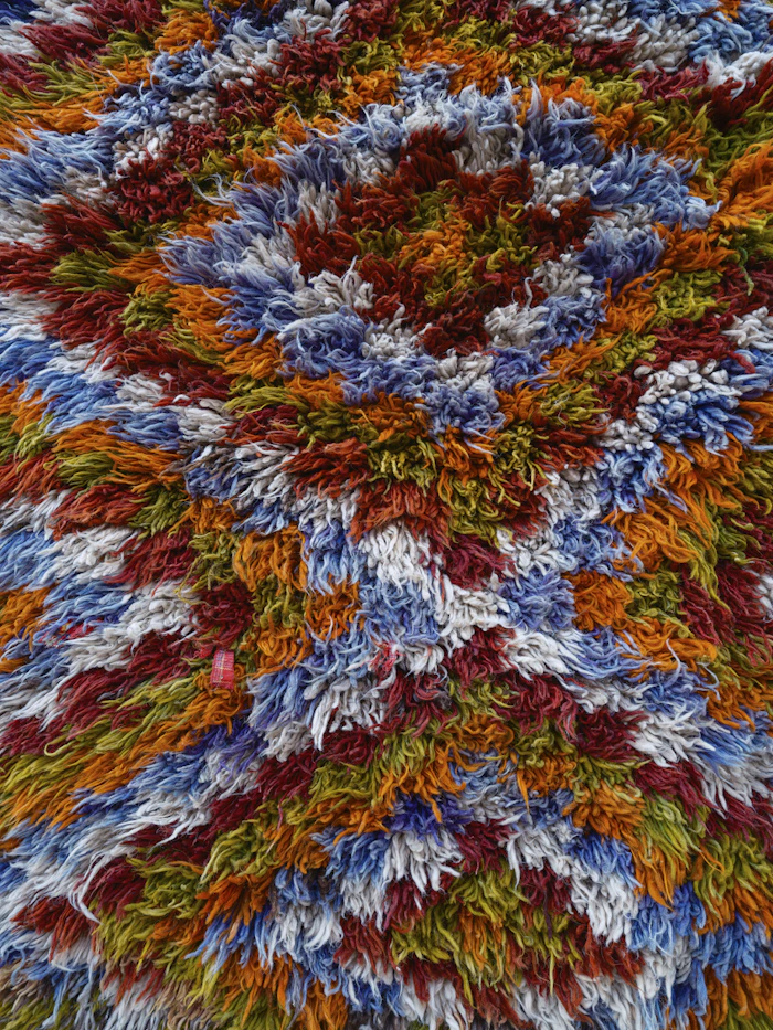 Multicoloured round rug with a bold circular medallion design