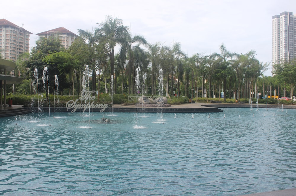 a large pool with a fountain in the middle of it