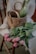 Close-up of a rustic jute basket holding magazines beside a wooden chair.