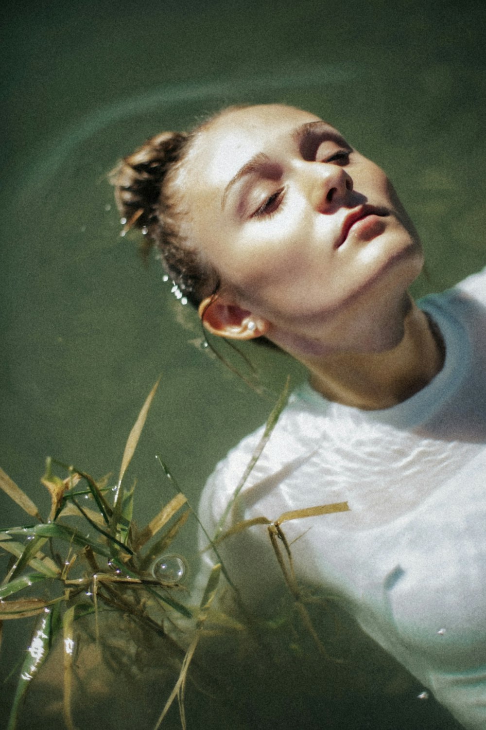 a woman is floating in a body of water