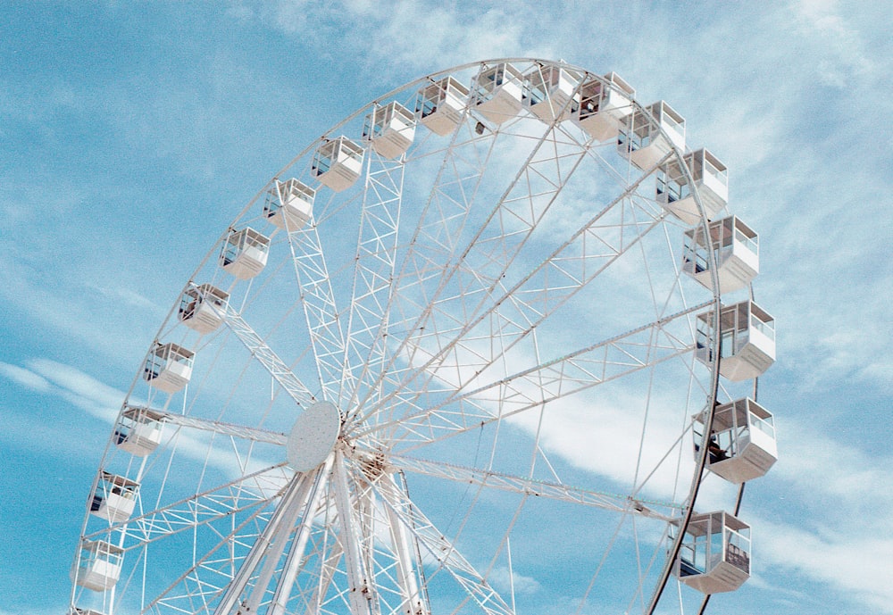 a large ferris wheel sitting under a blue sky