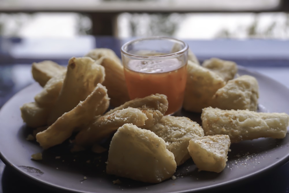 a plate of fried food with dipping sauce