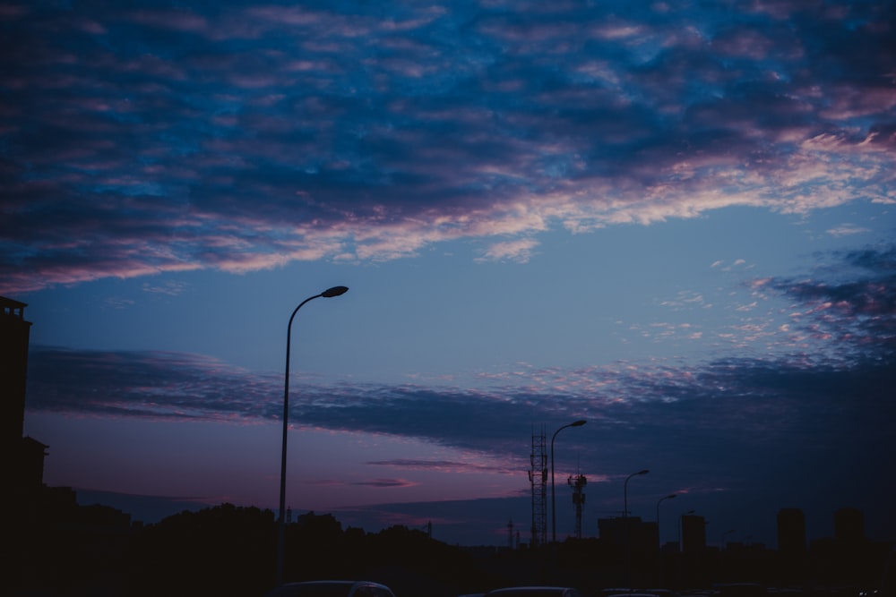 a street light in front of a cloudy sky