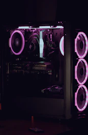 a computer case is lit up with purple lights
