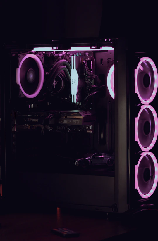 a computer case is lit up with purple lights