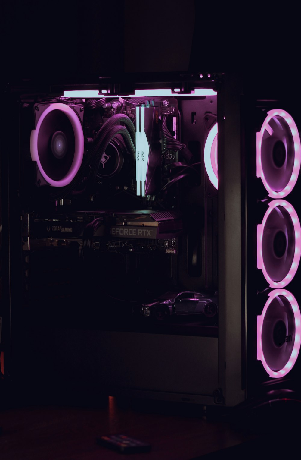 a computer case is lit up with purple lights