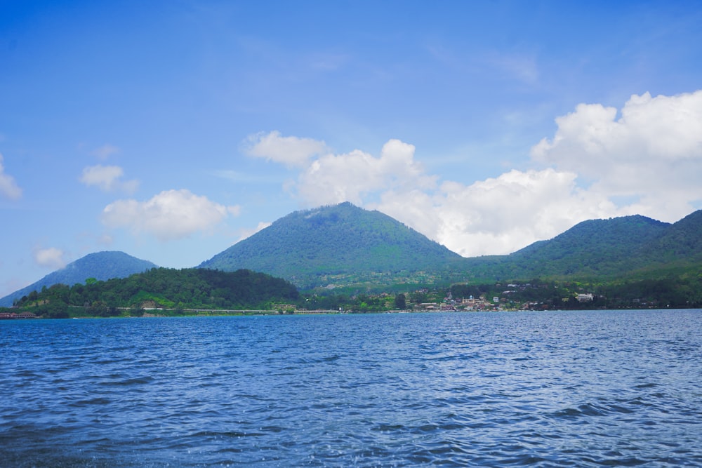 a body of water with mountains in the background