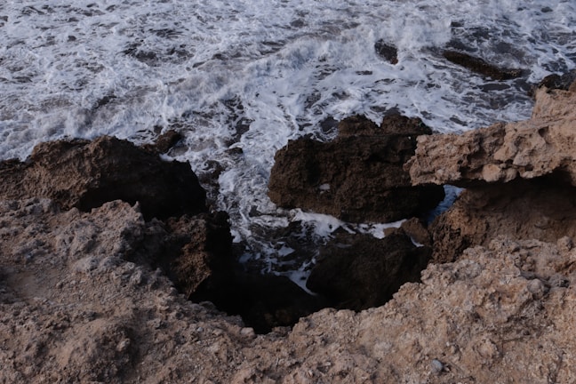 Coastal cliffs and waves crashing along Big Sur’s rugged shoreline.