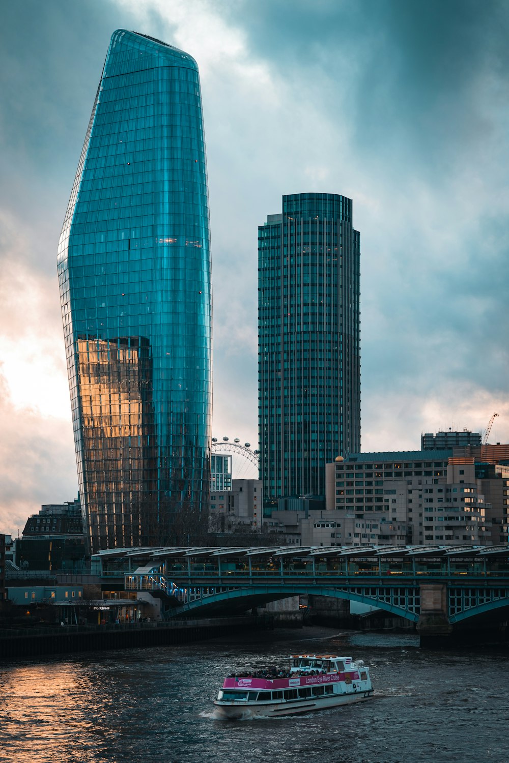 a boat traveling down a river next to tall buildings