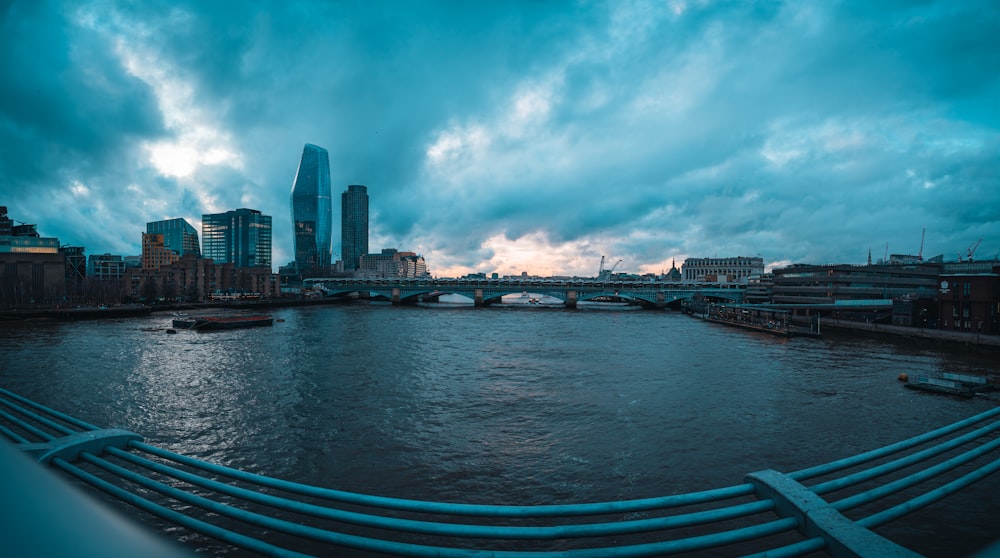 a view of a river with a bridge in the background