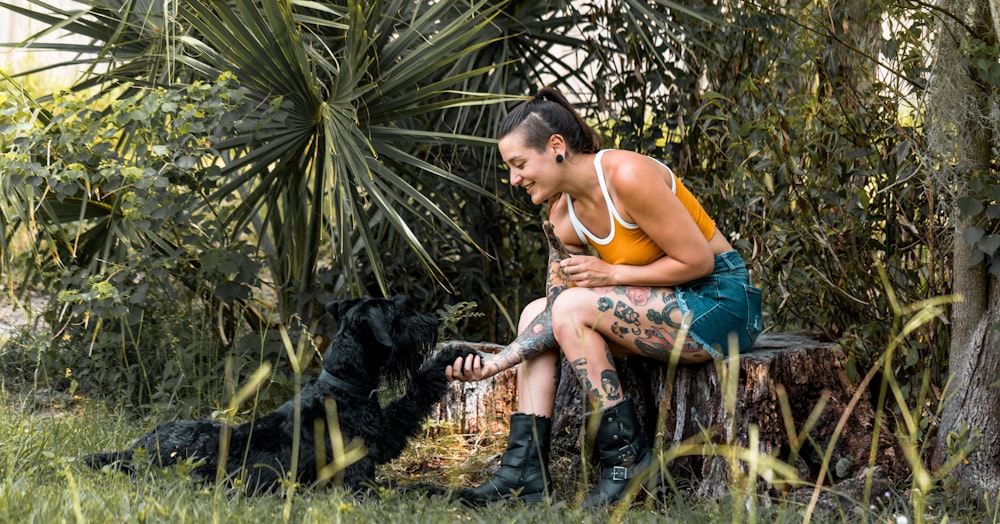 a woman sitting on a bench with a dog