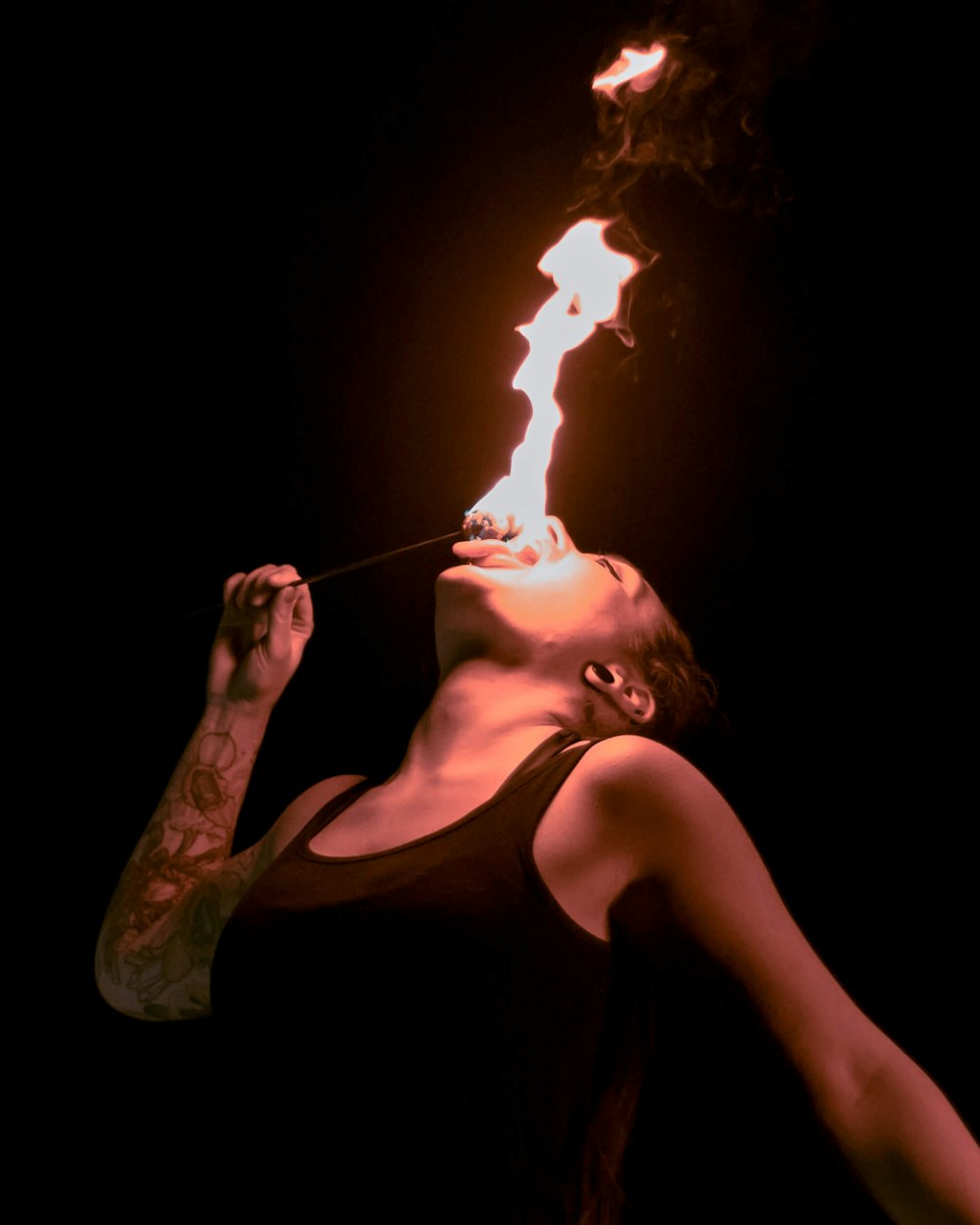 a woman holding a lit cigarette in her mouth