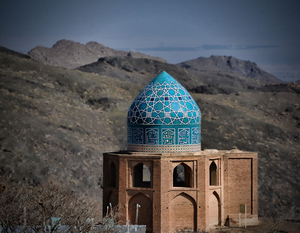 a blue dome on top of a brown building