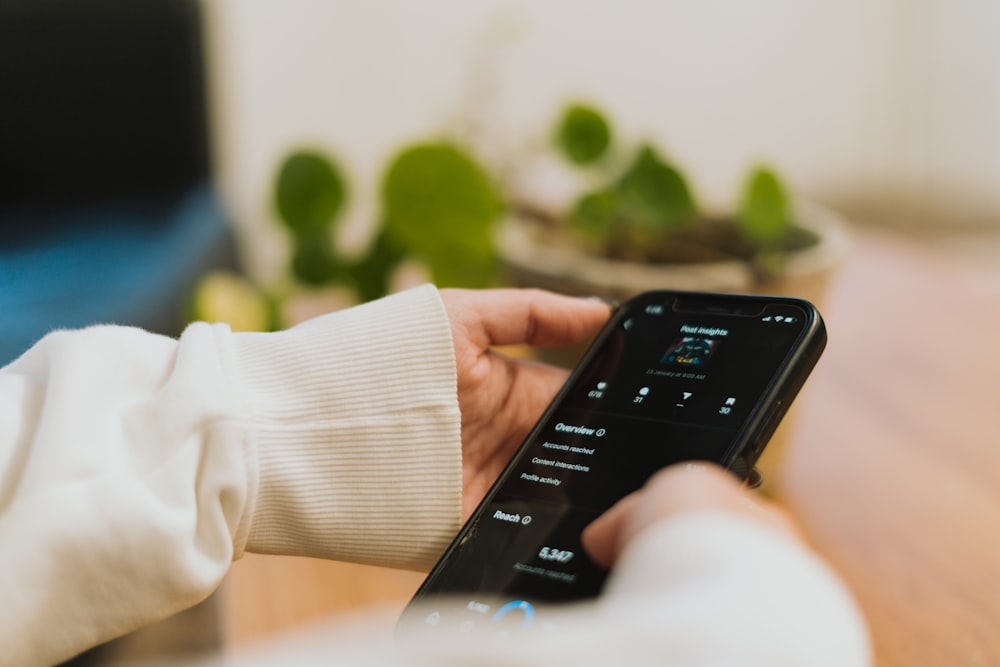 a person holding a remote control in their hand