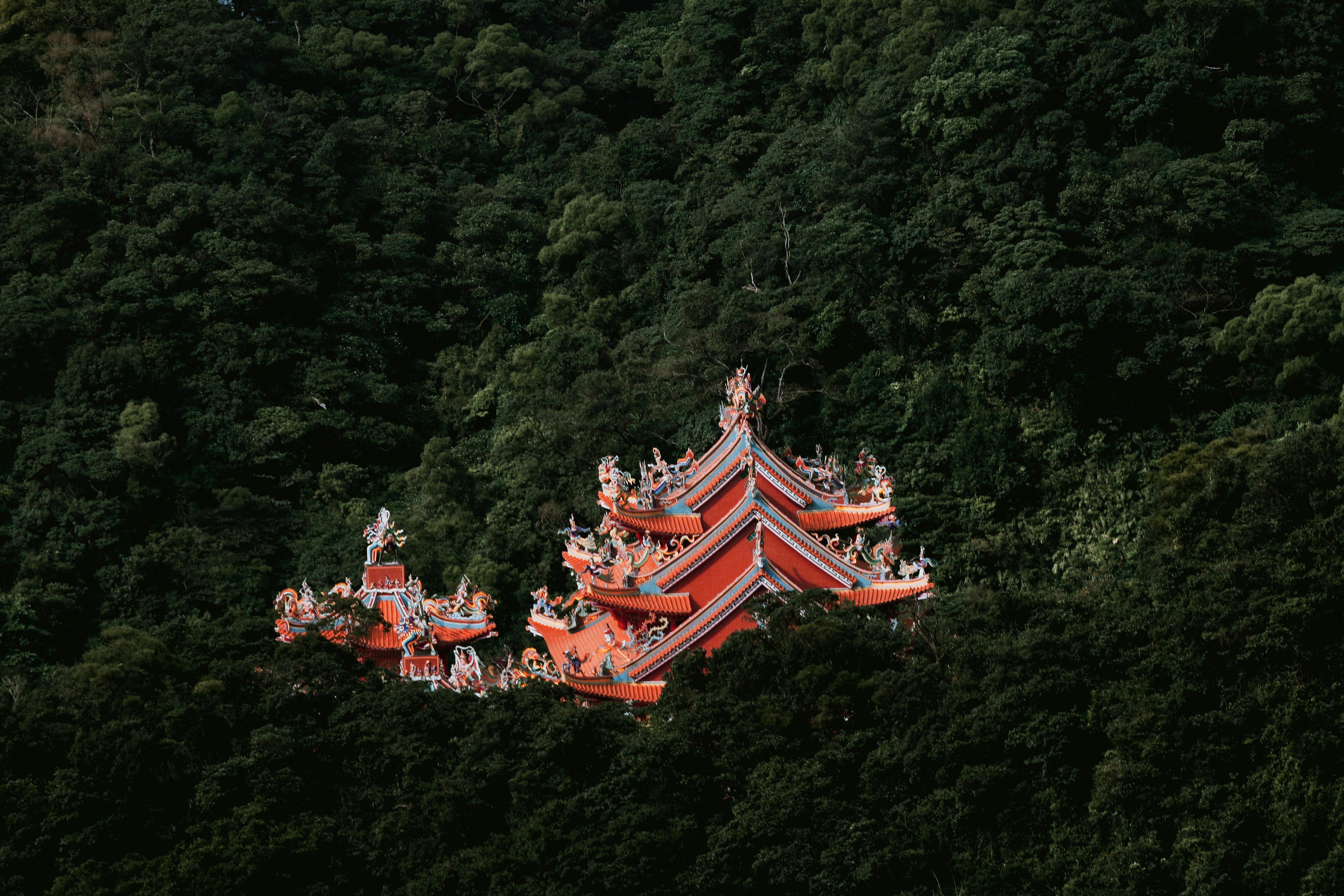 a group of people standing on top of a red building