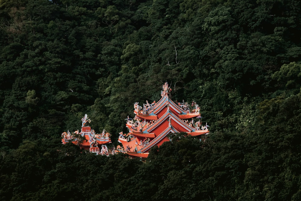 a group of people standing on top of a red building