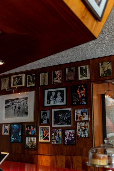 a wall covered in pictures and framed pictures