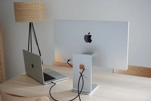 A sleek, modern workspace with golden lighting and a high-tech laptop displaying educational content.