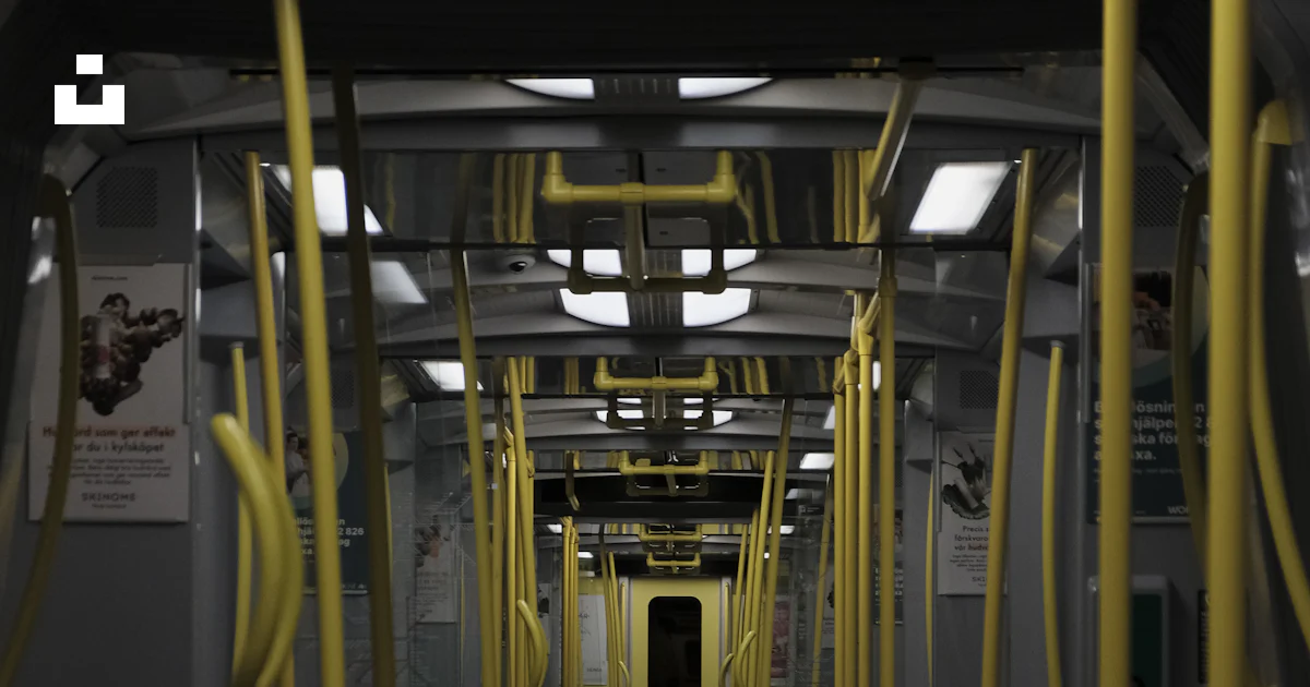A subway car with yellow railings and seats photo – Free Wallpaper ...