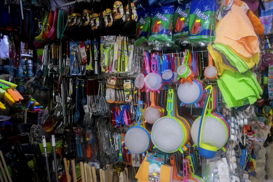 A vibrant display of household cleaning products like mops and brooms.