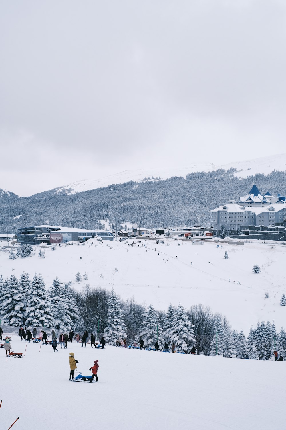 a group of people standing on top of a snow covered slope