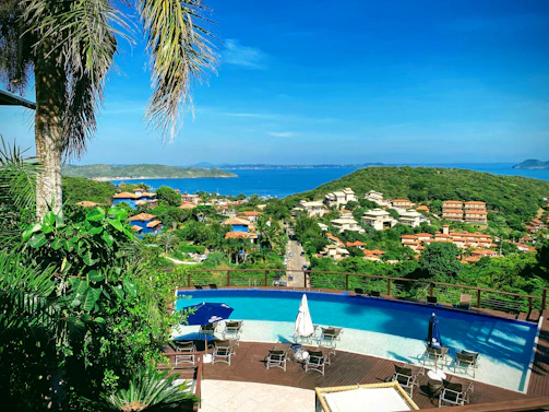 A panoramic shot of a luxury apartment balcony overlooking the turquoise Aegean Sea.