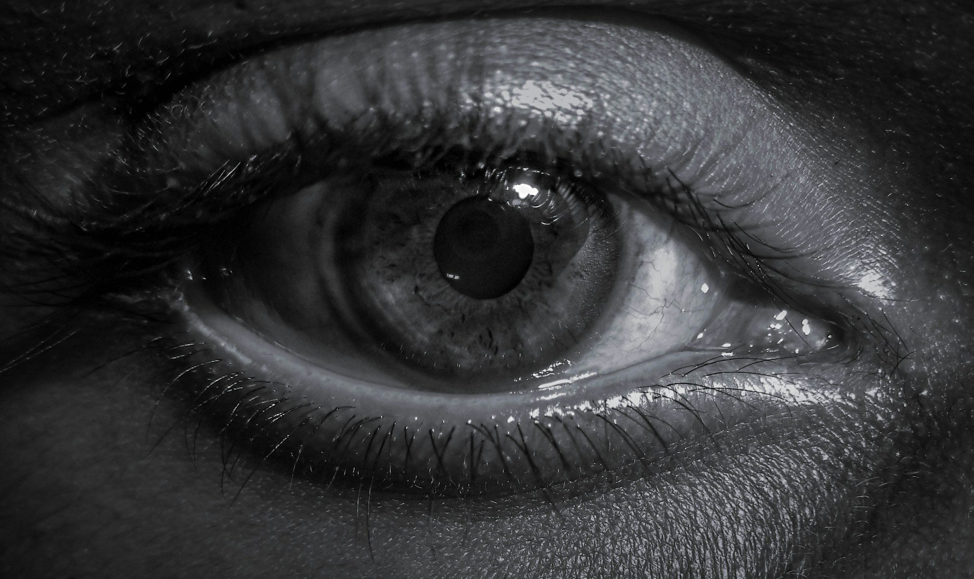 a black and white photo of a person's eye