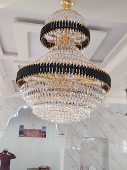 Professional fitter adjusting elegant curtains in a modern Saudi living room