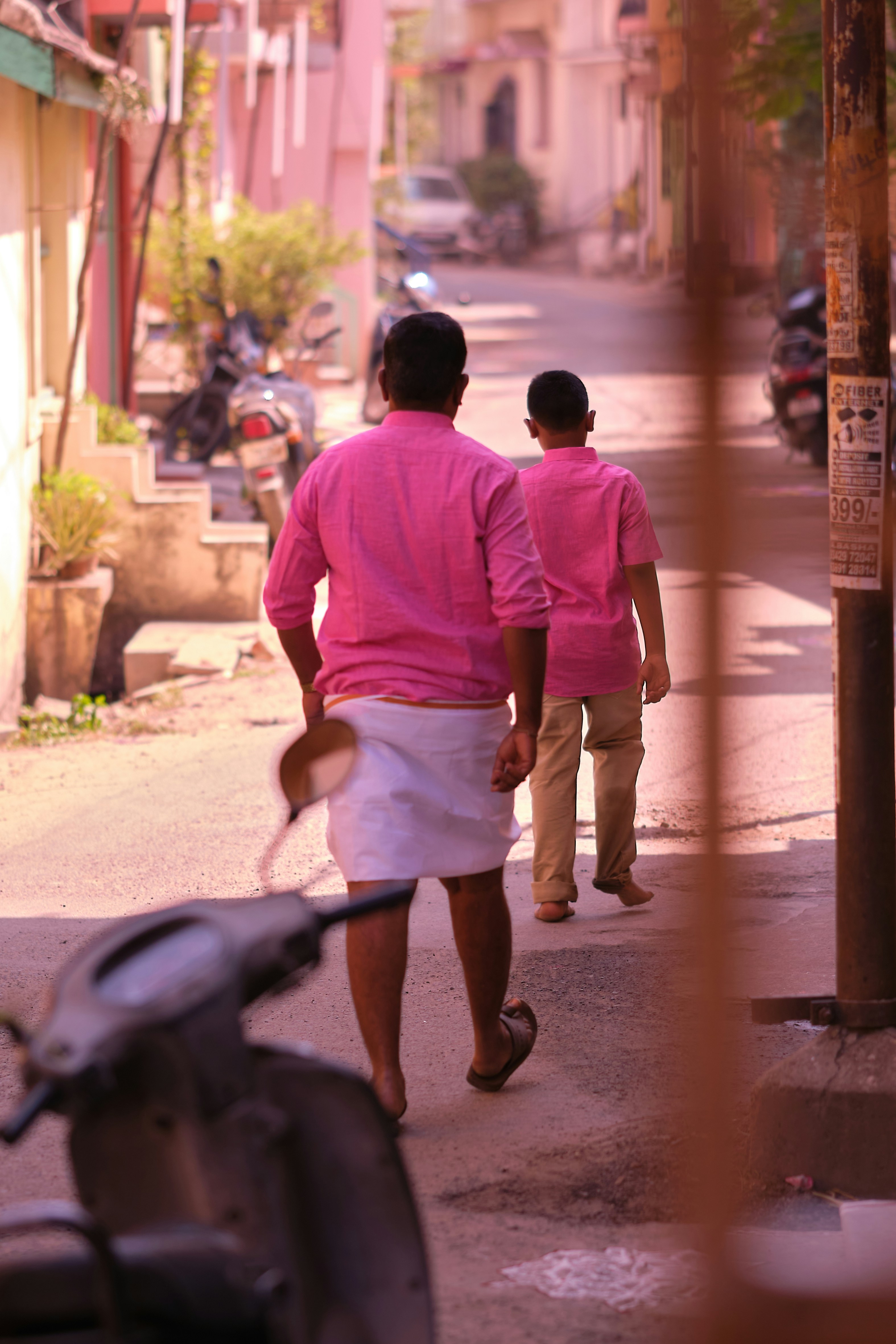 a couple of people walking down a street