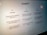 A close-up view of a computer screen displaying the ChatGPT interface. The screen is divided into three sections labeled 'Examples,' 'Capabilities,' and 'Limitations,' each containing text descriptions. The environment appears dimly lit, emphasizing the screen's brightness and focus.