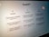 A close-up view of a computer screen displaying the ChatGPT interface. The screen is divided into three sections labeled 'Examples,' 'Capabilities,' and 'Limitations,' each containing text descriptions. The environment appears dimly lit, emphasizing the screen's brightness and focus.