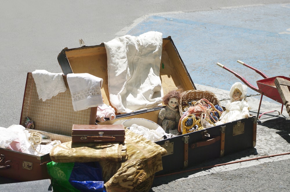 an open suitcase sitting on the side of the road