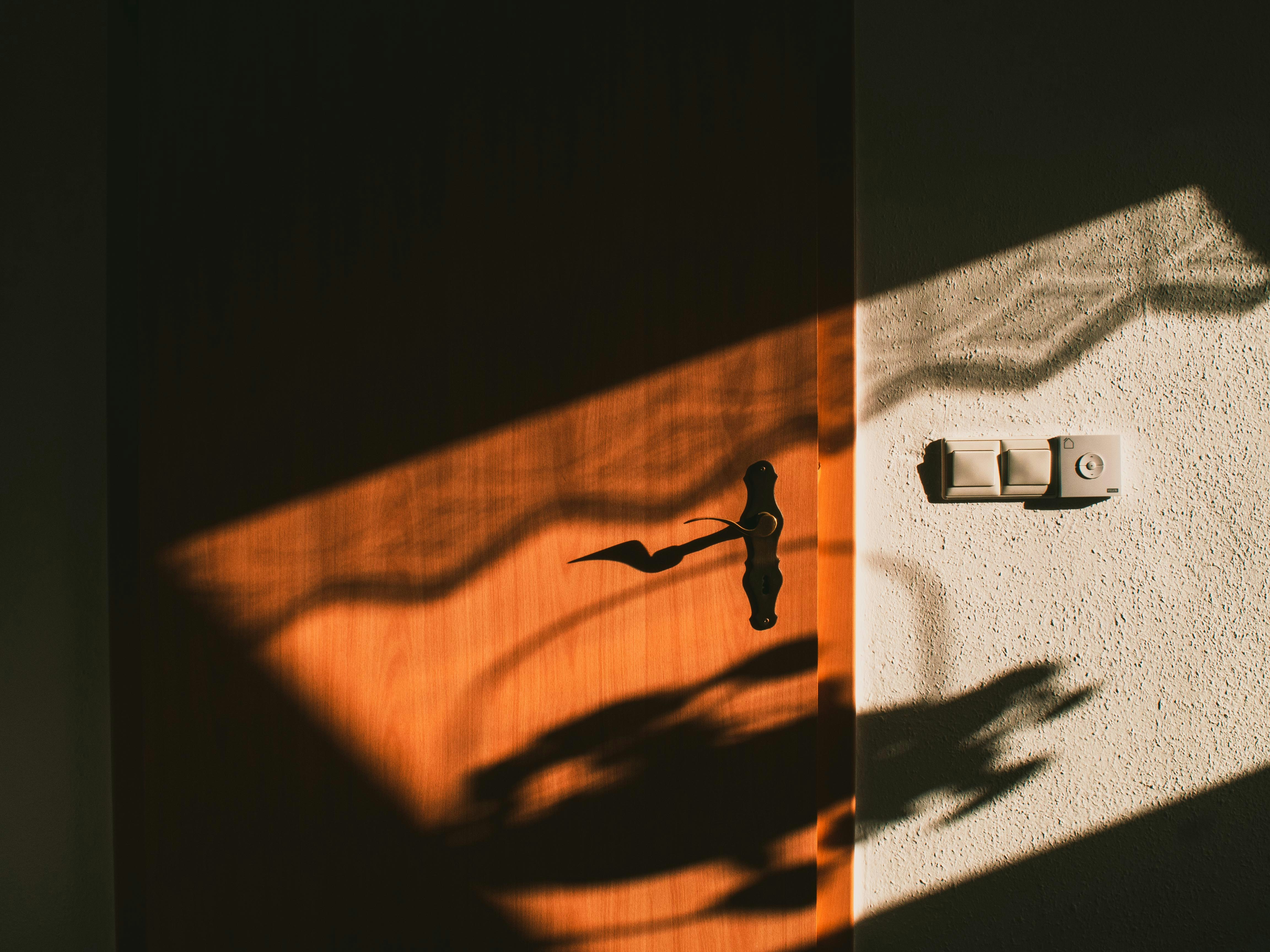 a shadow of a clock on a wall