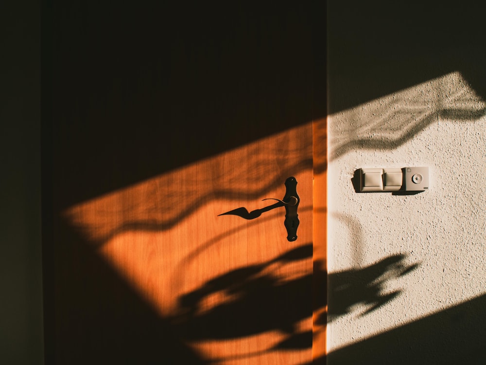 a shadow of a clock on a wall