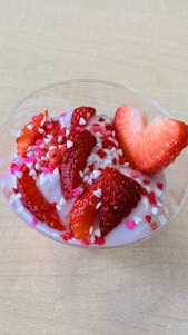 A colorful assortment of frozen yogurt cups topped with fresh berries and sprinkles.