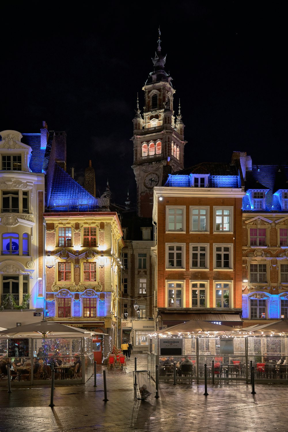 a large clock tower towering over a city at night