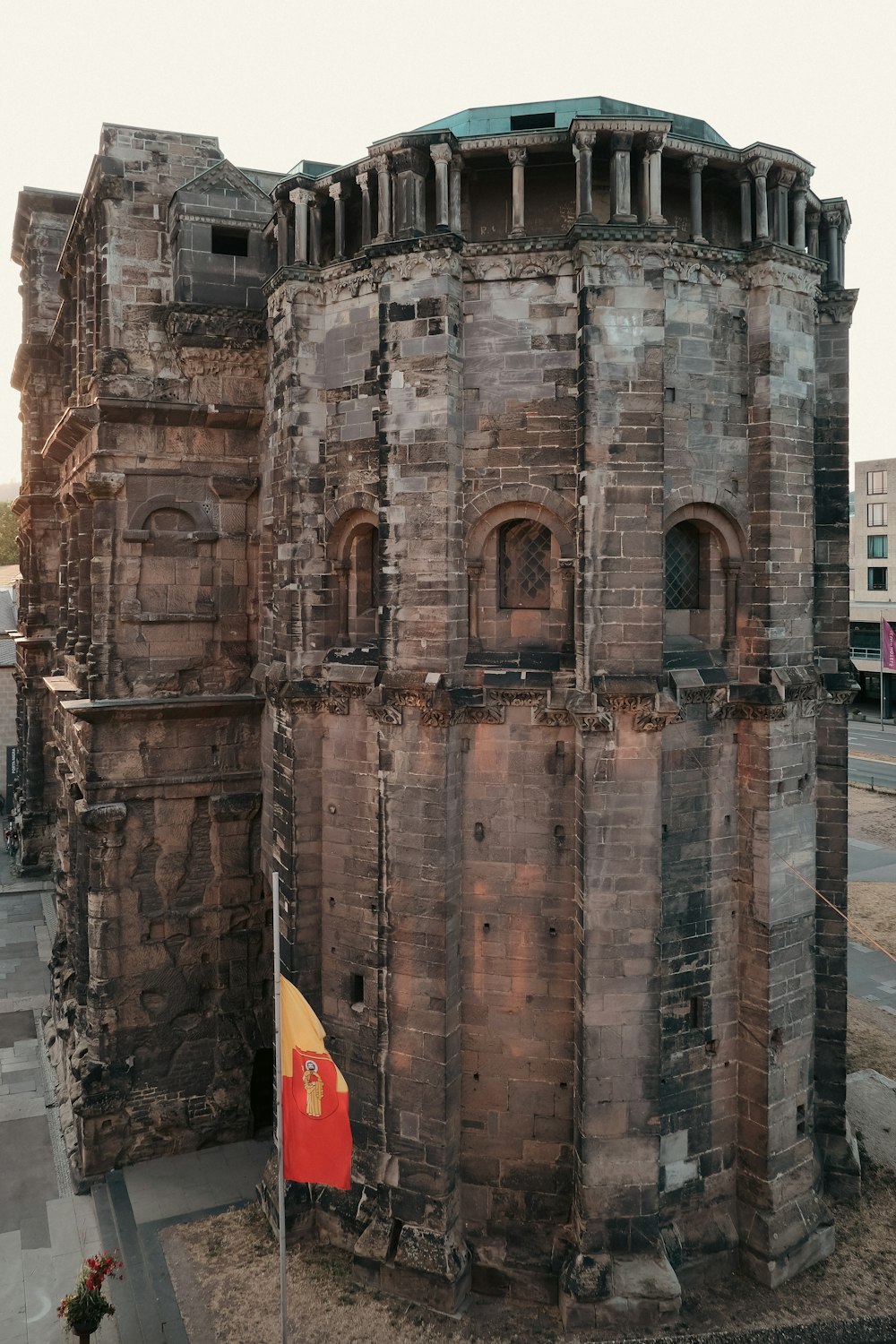 a large brick tower with a flag on top of it