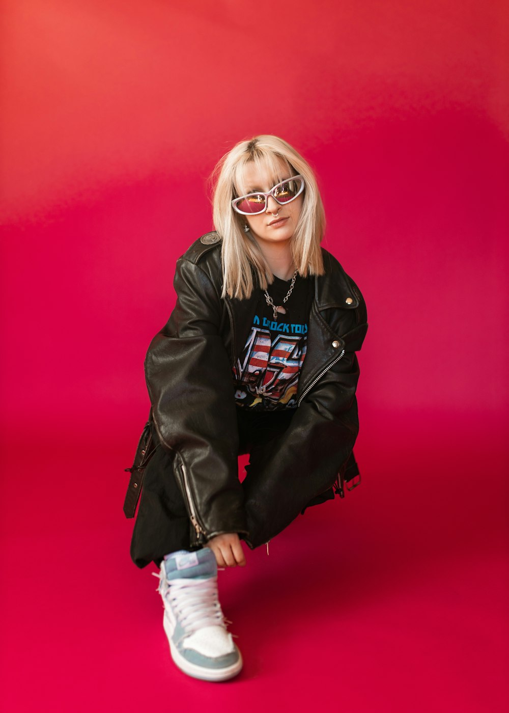 a woman wearing sunglasses and a leather jacket