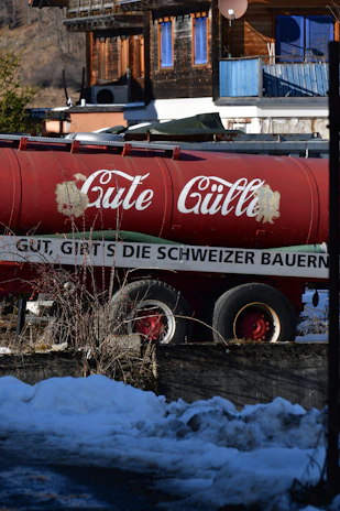 A close-up of a water tanker parked near a dusty rural road ready for service.