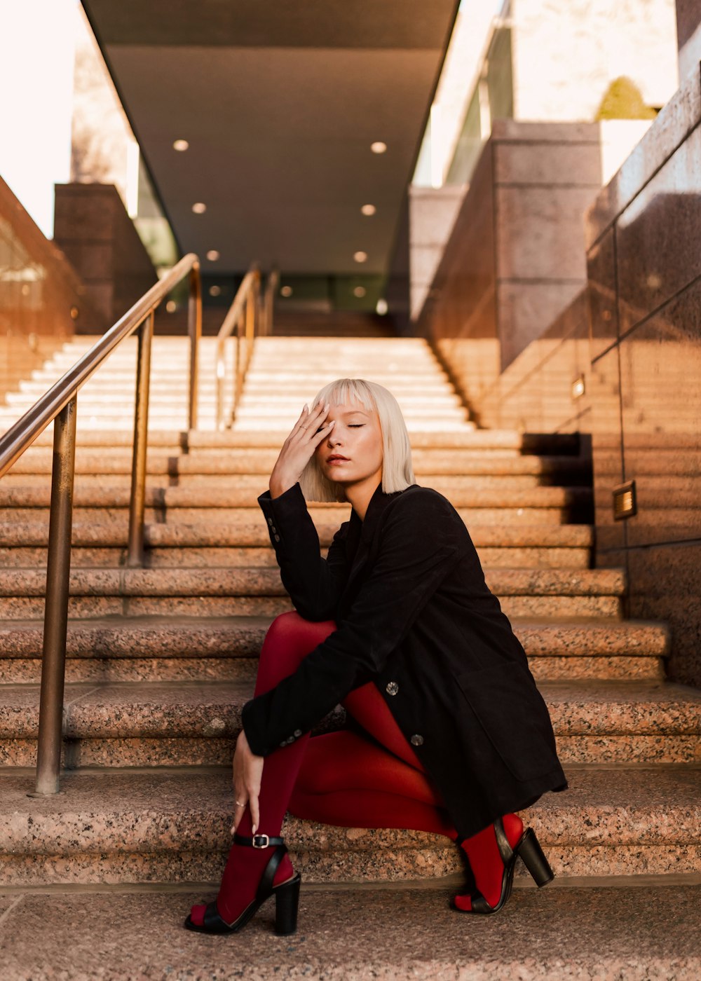 a woman sitting on the steps of a building