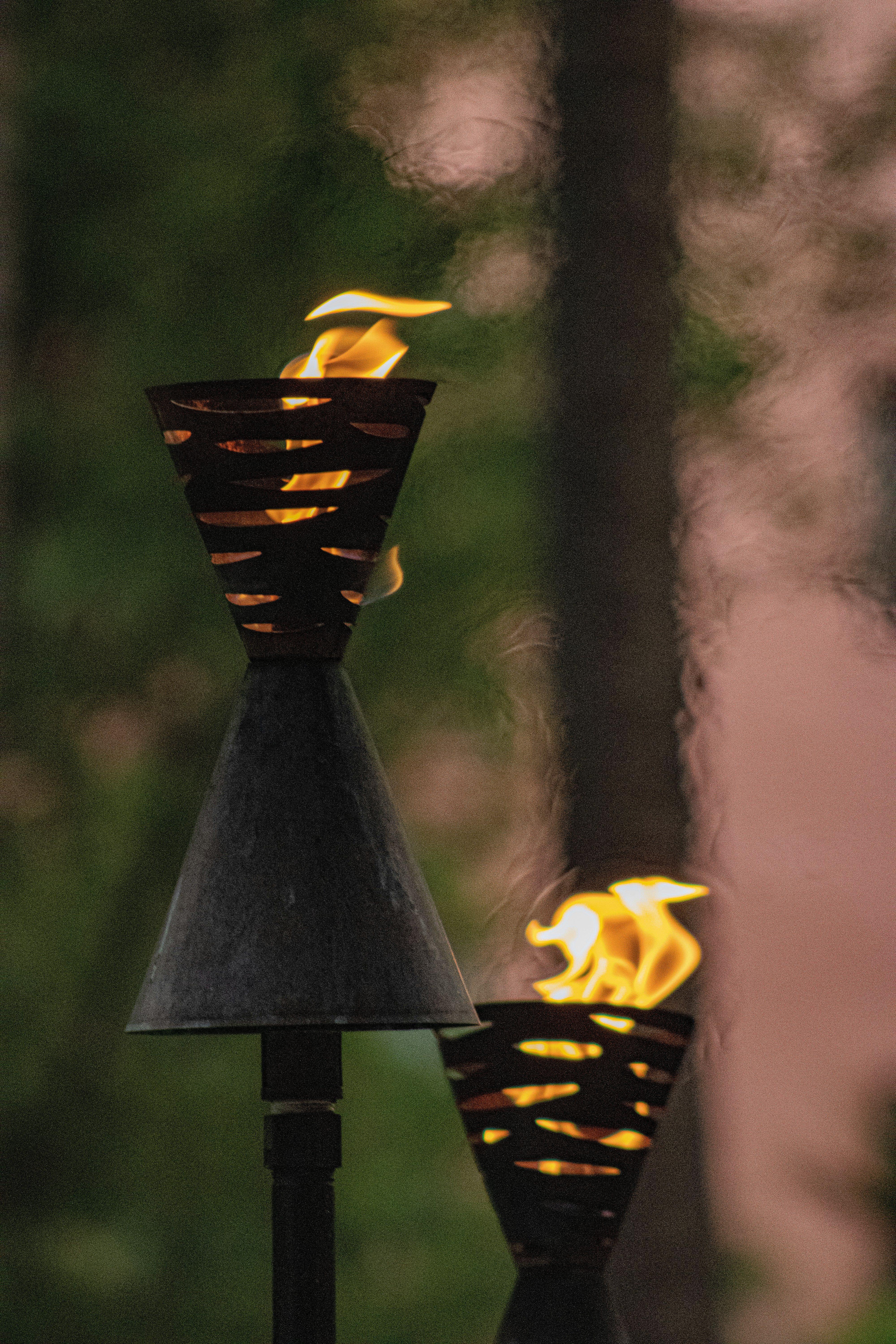 a couple of metal lamps sitting on top of a table