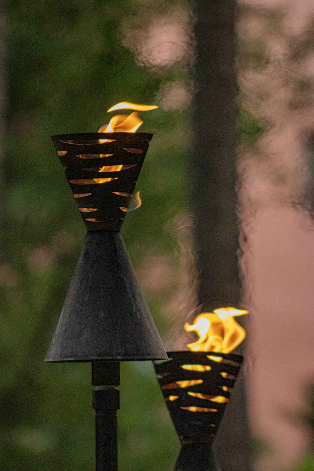 a couple of metal lamps sitting on top of a table