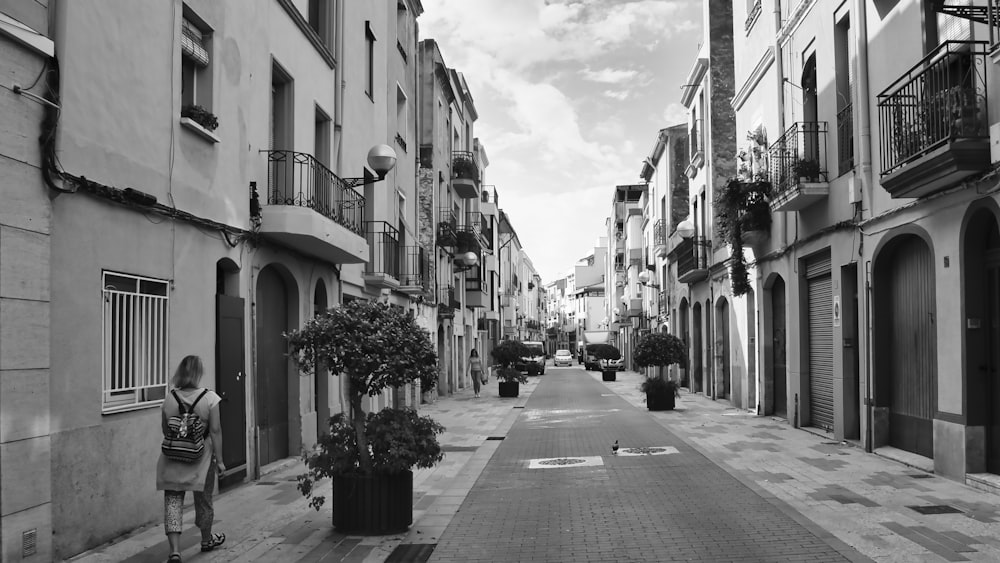 a black and white photo of a narrow street