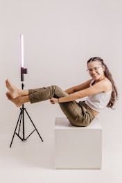 a woman sitting on top of a white box